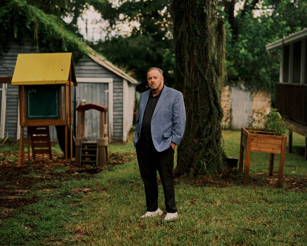 Mike Carroll stands in the yard of Hands of Mercy Everywhere maternity home in Belleview, Florida.